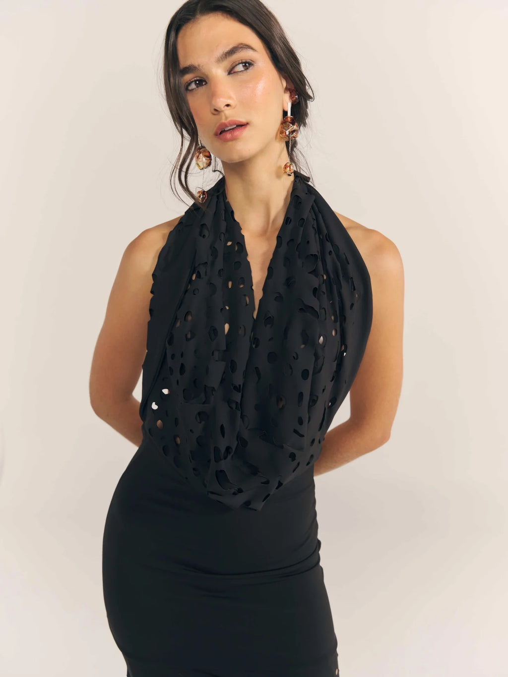 Vestido de gala negro con perforaciones inspiradas en formas orgánicas